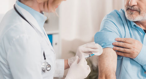 Clinician givinf a patient a vaccination